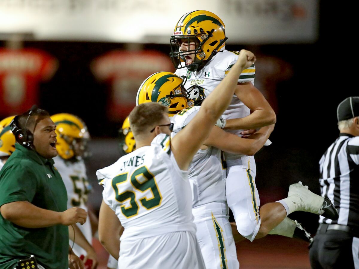 Edison linebacker Dylan Walters (6) leaps for joy toward the bench after he and the defense stopped a fourth-and-inches play.