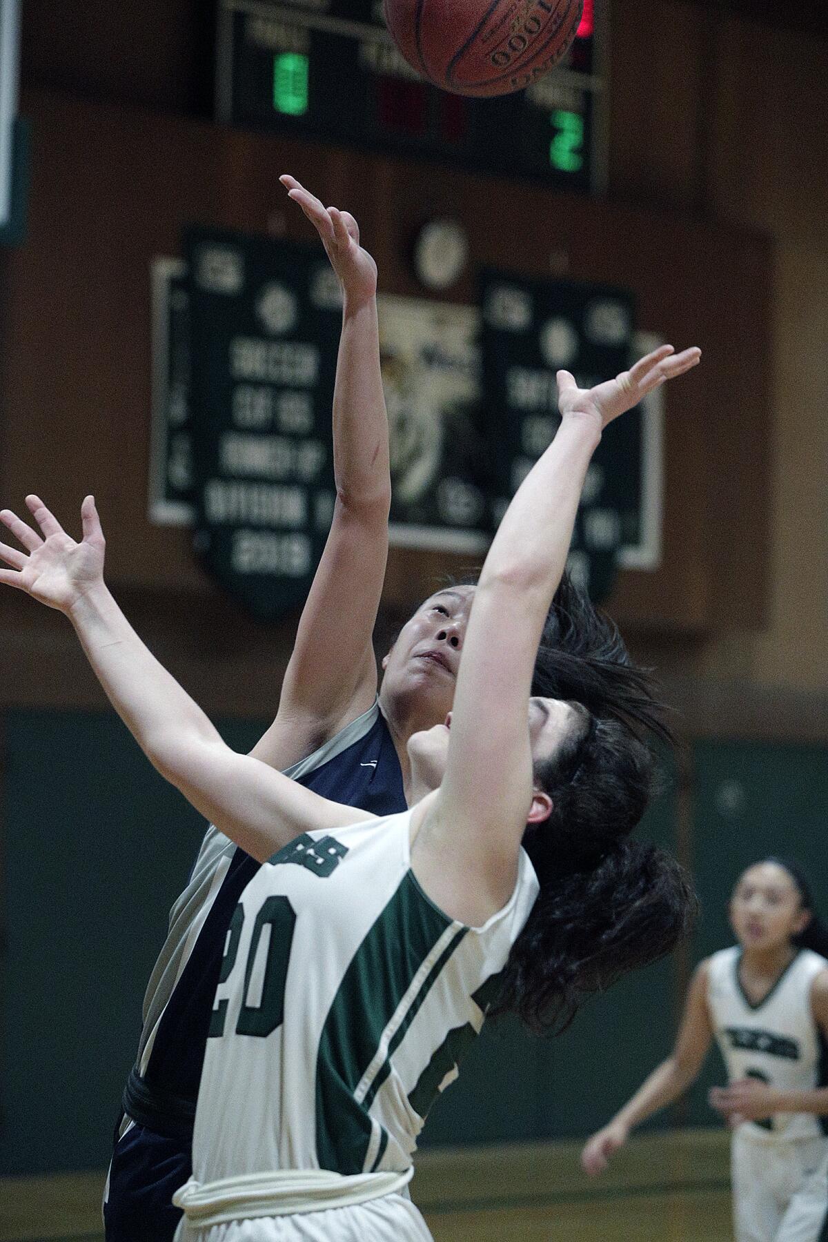 Flintridge Prep's Kaitlyn Chen and Westridge's Mia Hakian battle for a rebound in a Prep League girls' basketball game at Westridge School in Pasadena on Thursday, January 16, 2020.