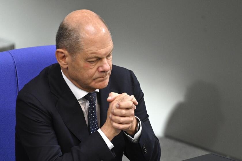 German Chancellor Olaf Scholz attends a minute of silence at the German parliament Bundestag in Berlin, Germany, Wednesday, Oct.11, 2023. (AP Photo/Stefanie Loos)