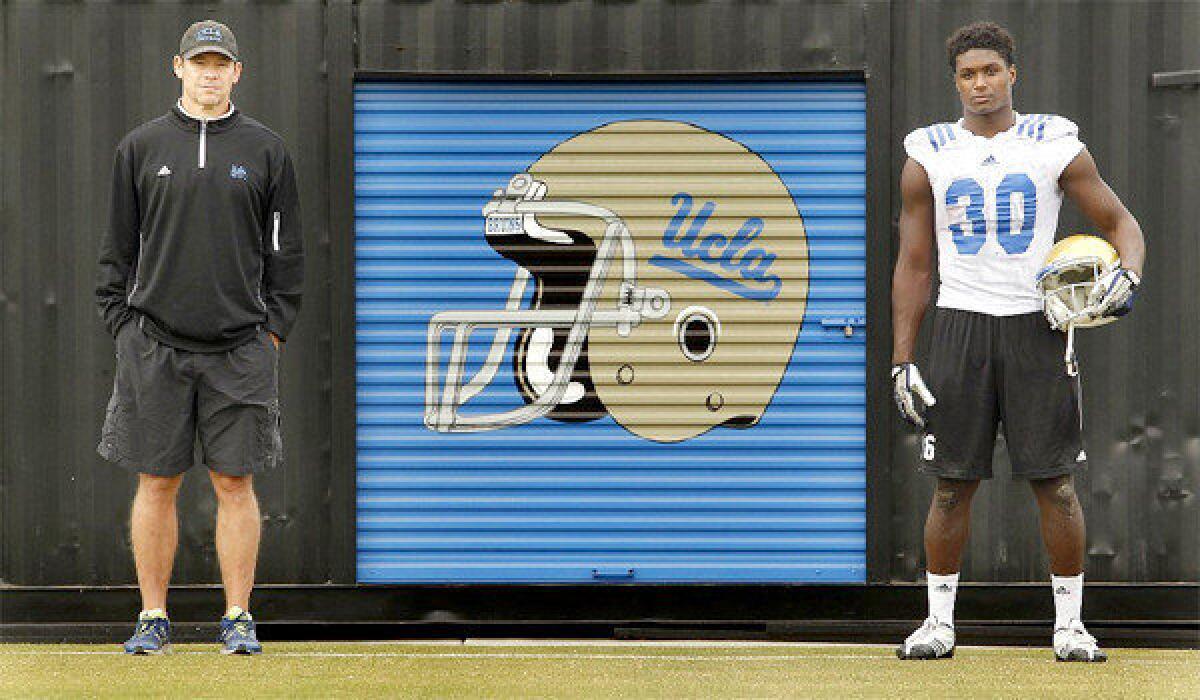 UCLA Coach Jim Mora and freshman star linebacker Myles Jack, both from Bellevue, Wash., stand at the Bruins' practice facility at Spaulding Field.