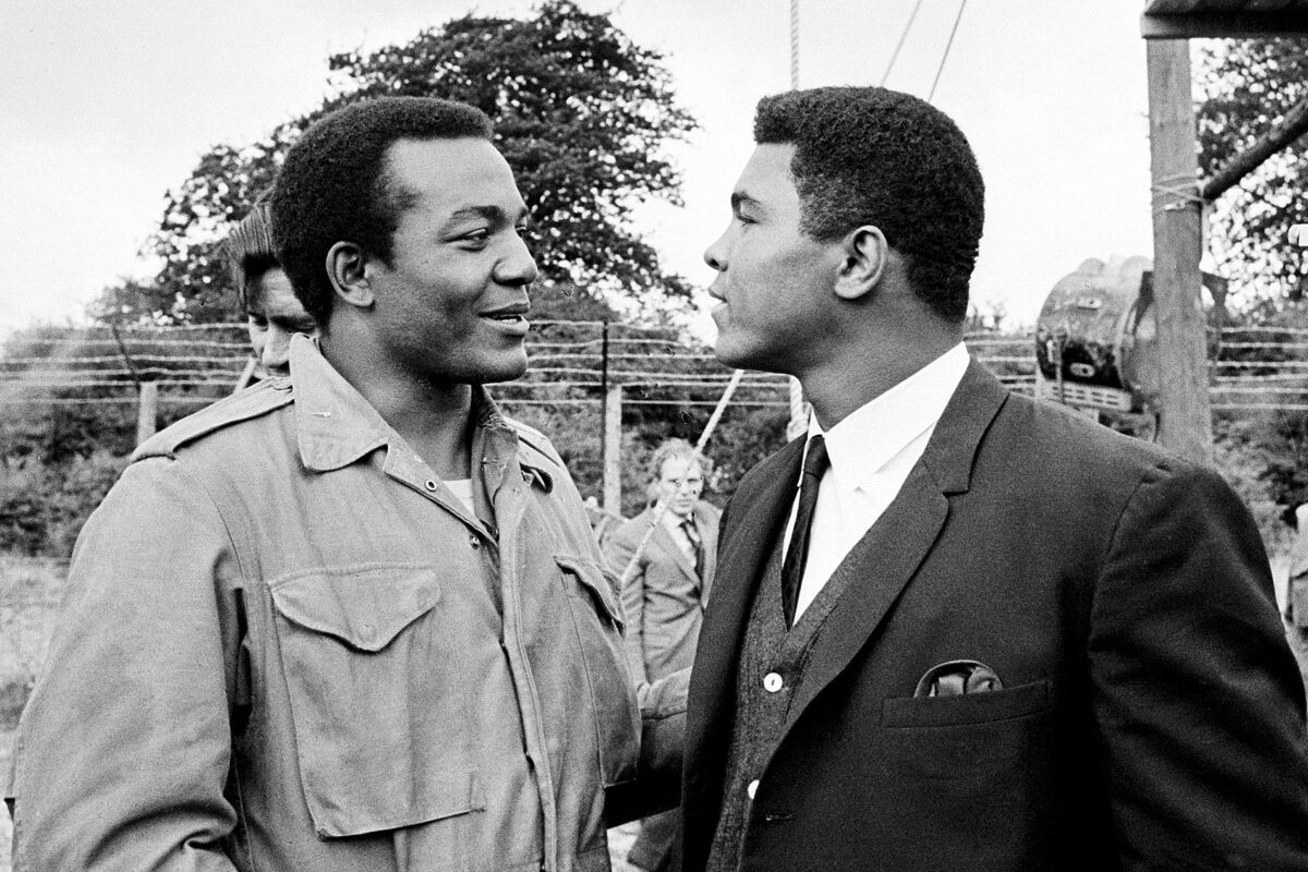 Jim Brown, left, and boxing legend Muhammad Ali talk on the set of "The Dirty Dozen" in England.