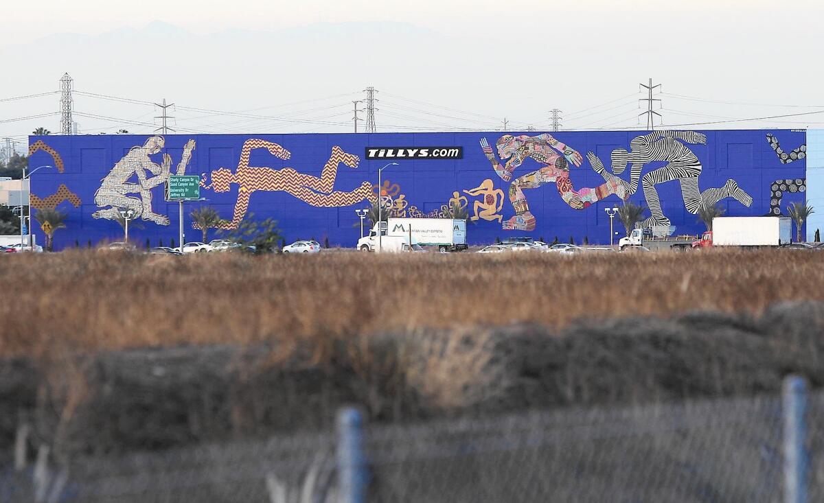 This mural by artist Zio Ziegler occupies the 55-by-340-foot wall of Tilly's offices alongside the 405 Freeway in Irvine.