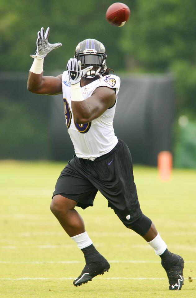 Linebacker Pernell McPhee looks a ball into his hands during a drill.