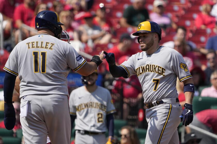 Milwaukee Brewers' Victor Caratini (7) is congratulated by teammate Rowdy Tellez (11) after hitting a three-run home run during the sixth inning of a baseball game against the St. Louis Cardinals Thursday, Sept. 21, 2023, in St. Louis. (AP Photo/Jeff Roberson)