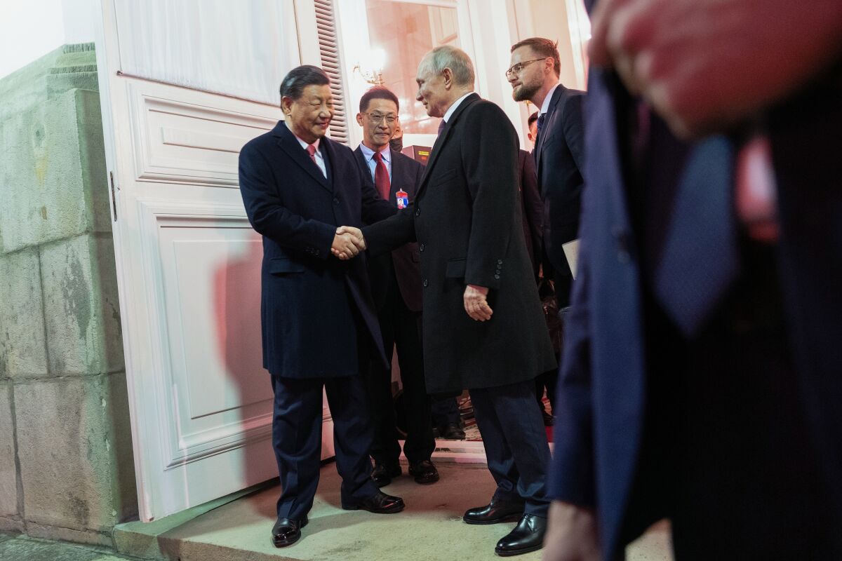 Chinese President Xi Jinping, left, shakes hands with Russian President Vladimir Putin as he leaves after their dinner at The Palace of the Facets in the Moscow Kremlin, Russia, Tuesday, March 21, 2023. (Pavel Byrkin, Sputnik, Kremlin Pool Photo via AP)