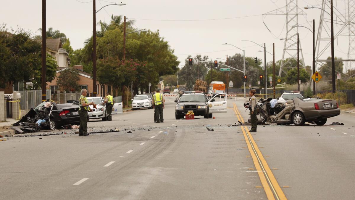 Los Angeles County Sheriff's deputies take measurements at the scene of a fatal collision in Pico Rivera early Monday.