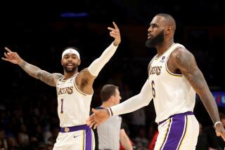 Los Angeles, CA - April 09: Lakers guard D'Angelo Russell, left, celebrates a three-pointer by forward LeBron James against the Jazz in the first quarter at Crypto.com Arena in Los Angeles on Sunday, Apr. 9, 2023. (Luis Sinco / Los Angeles Times)