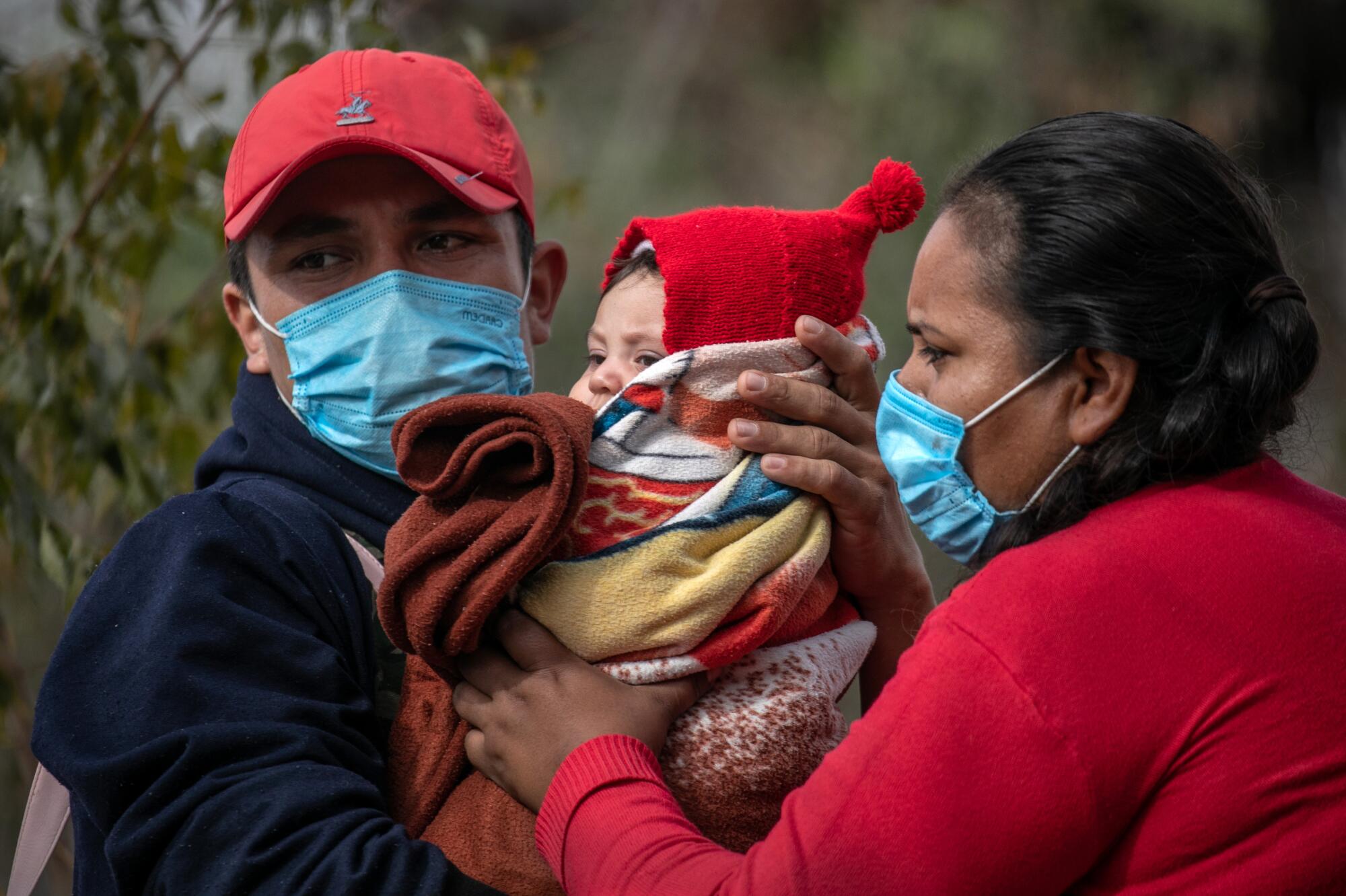 Two adults and a baby.