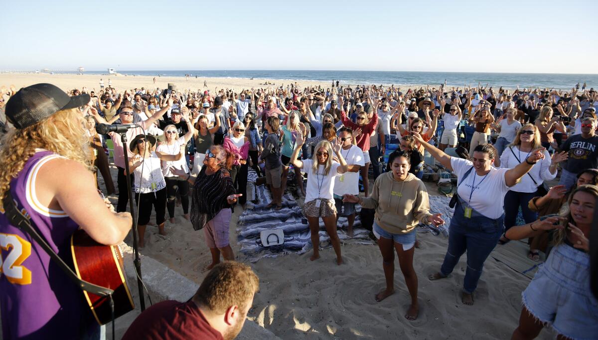 Hundreds gathered for the Saturate OC worship event held north of the pier in Huntington Beach, on Friday, July 10.