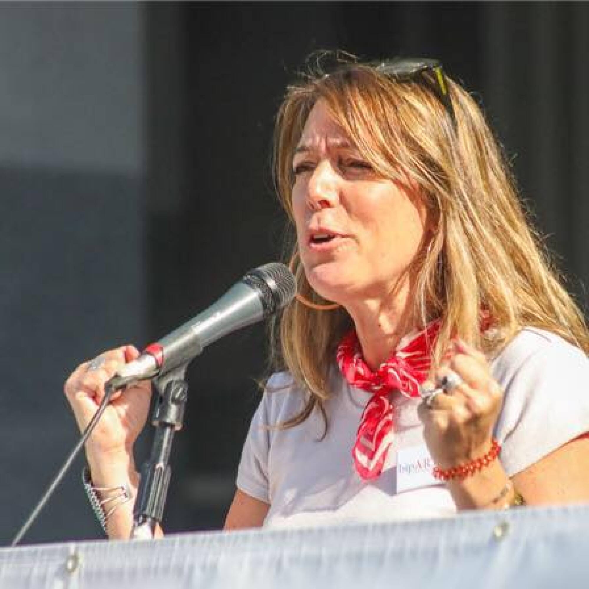 A woman speaks into a microphone