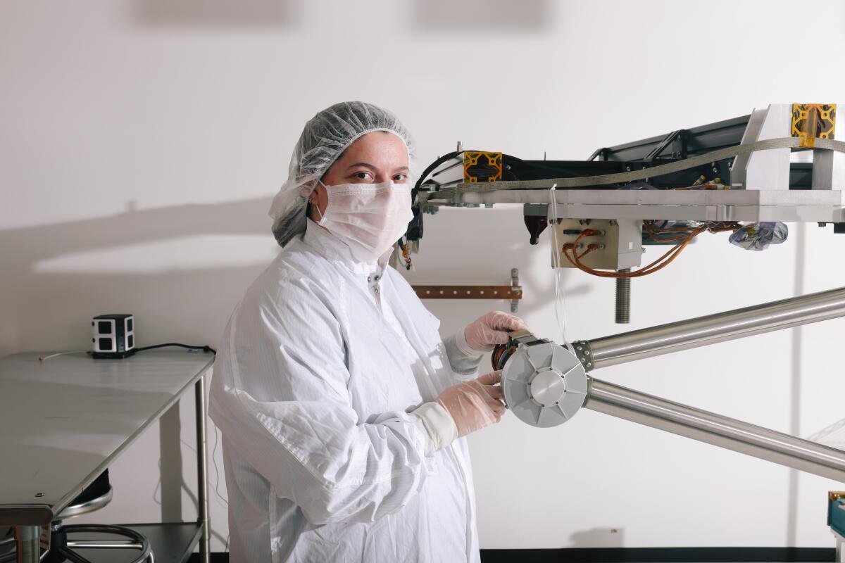 Lacie Fradet, a project engineer at Motiv Space Systems in Pasadena, with COLDArm, a robotic arm for a lunar rover.