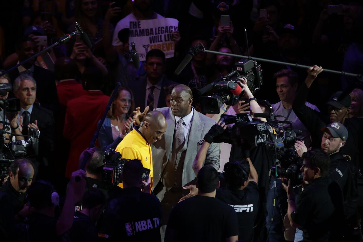 Kobe Bryant and Magic Johnson before Bryant's last game as a Laker.