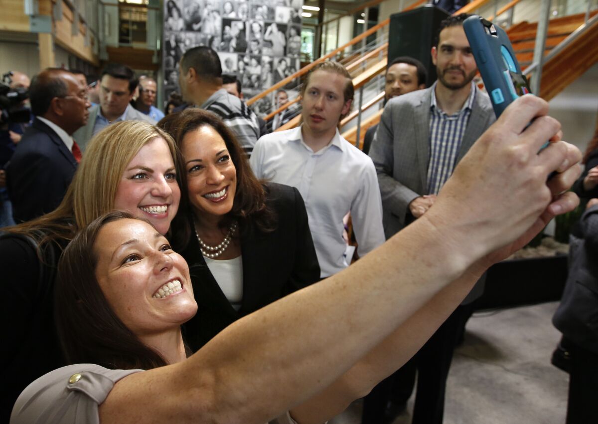 California Atty. Gen. Kamala Harris, third from left, takes a photo with supporters in Sacramento.