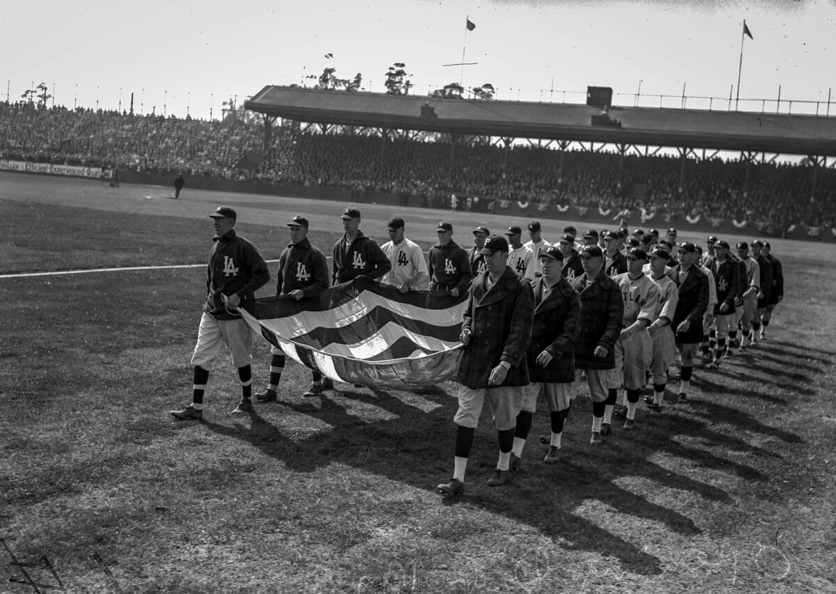 April 7, 1925: Members of the Los Angeles Angels and Portland Beavers carry Old Glory for flag-raising ceremonies during the season opener.