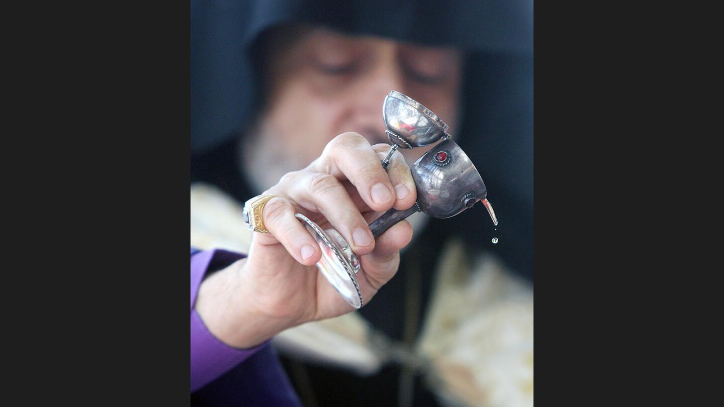 His Eminence Archbishop Hovnan Derderian, of the Western Diocese Armenian Church drips holy oil into blessed water at Adventist Health Center in Glendale to celebrate Armenian Christmas on Friday, January 5, 2018. About 50 people, including Glendale City Council members, Glendale Police, and hospital staff, were in attendance.