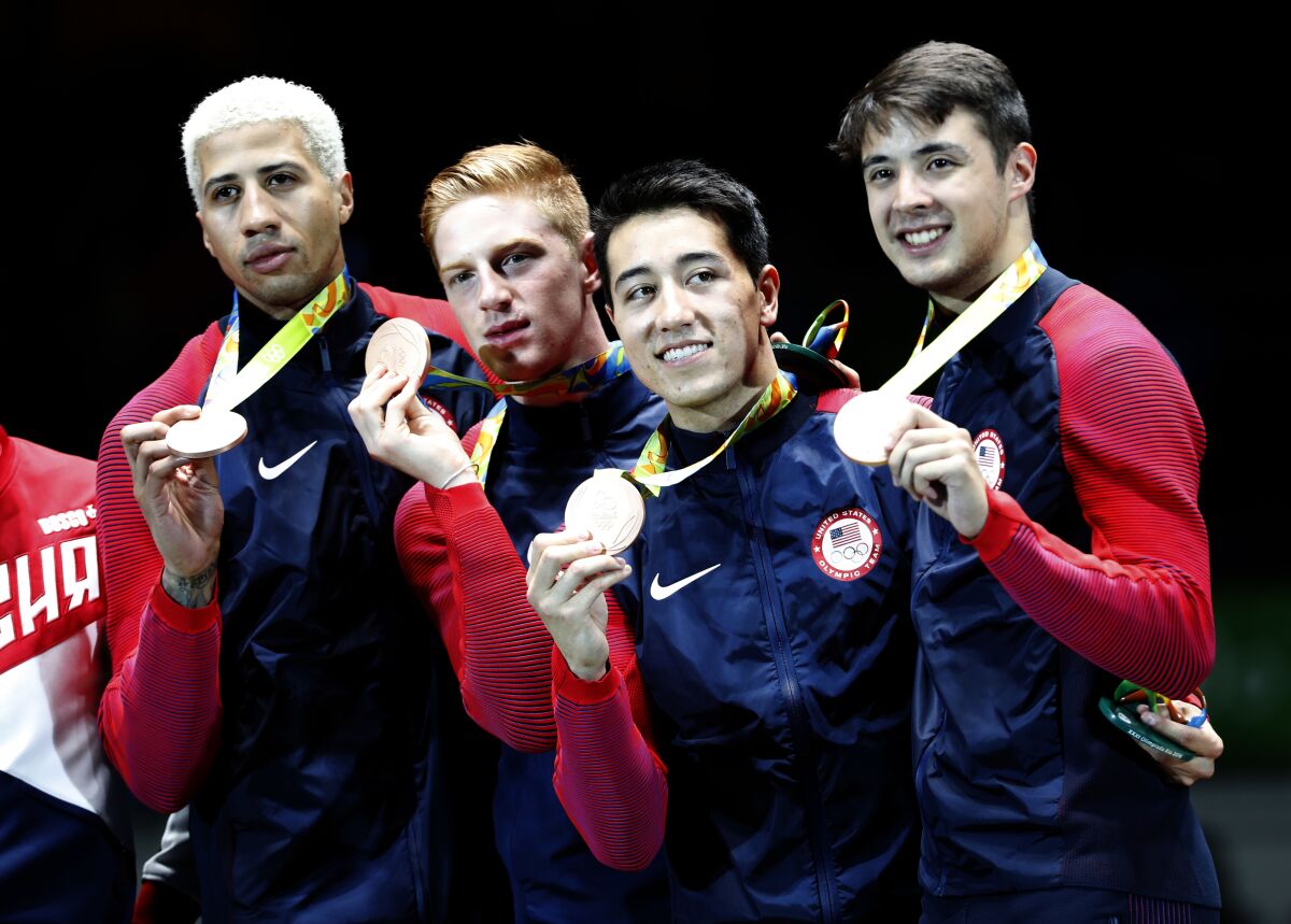 U.S. fencers Miles Chamley-Watson, Race Imboden, Alexander Massialas, and Gerek Meinhardt show off their 2016 Olympic medals 
