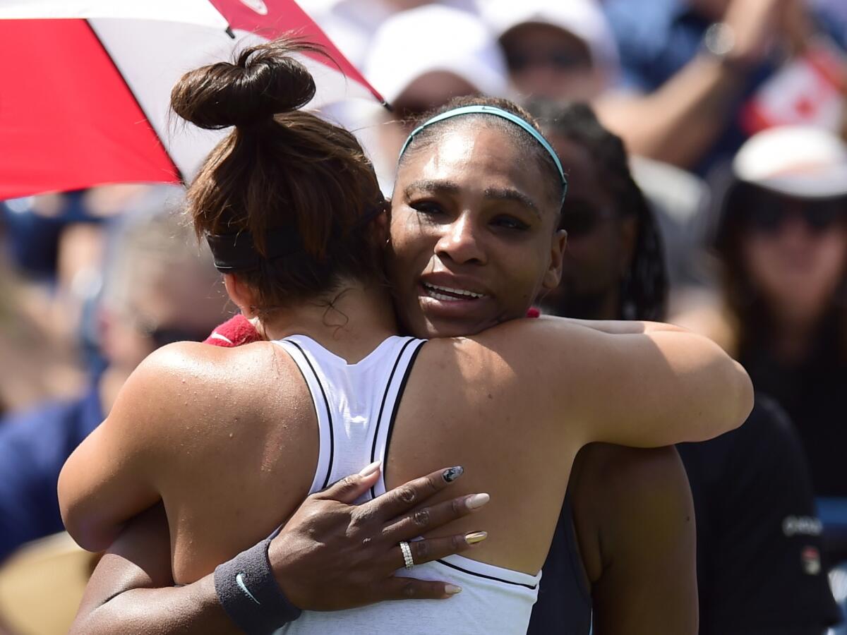 Serena Williams fights back tears as she embraces Rogers Cup winner Bianca Andreescu on Sunday in Toronto.