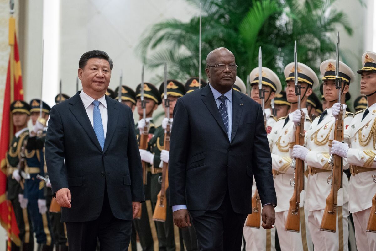 China's Xi Jinping, left, and President of Burkina Faso Roch Marc Christian Kabore