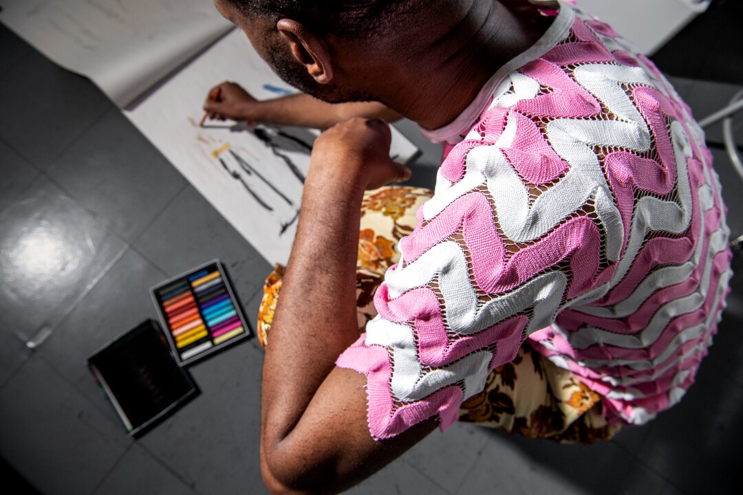 Kenneth Nicholson wearing a pink and white crochet lace top.