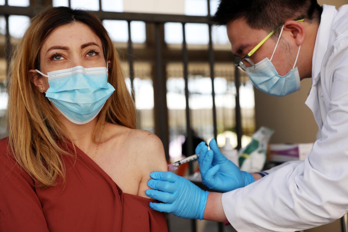 A woman receives a COVID-19 vaccine.