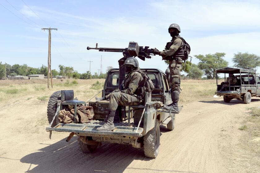 A photo taken on Nov. 12 shows Cameroonian soldiers patrolling in Amchide, less than a mile from the border with Nigeria. The military on Jan. 19 reported it had rescued at least two dozen hostages seized by Boko Haram in Cameroon the day before.