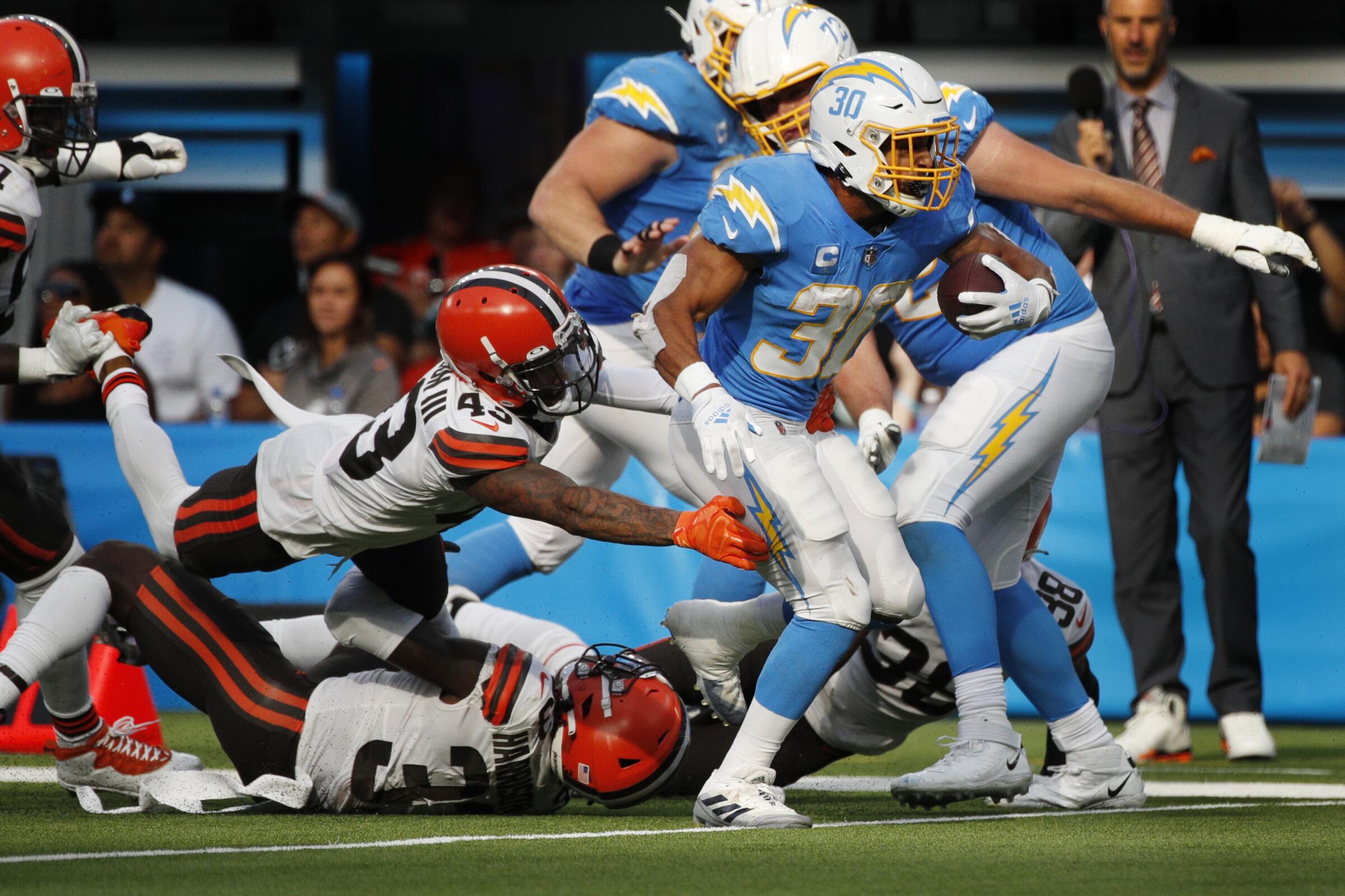 Chargers running back Austin Ekeler breaks free from the tackle attempt by Cleveland Browns free safety John Johnson.