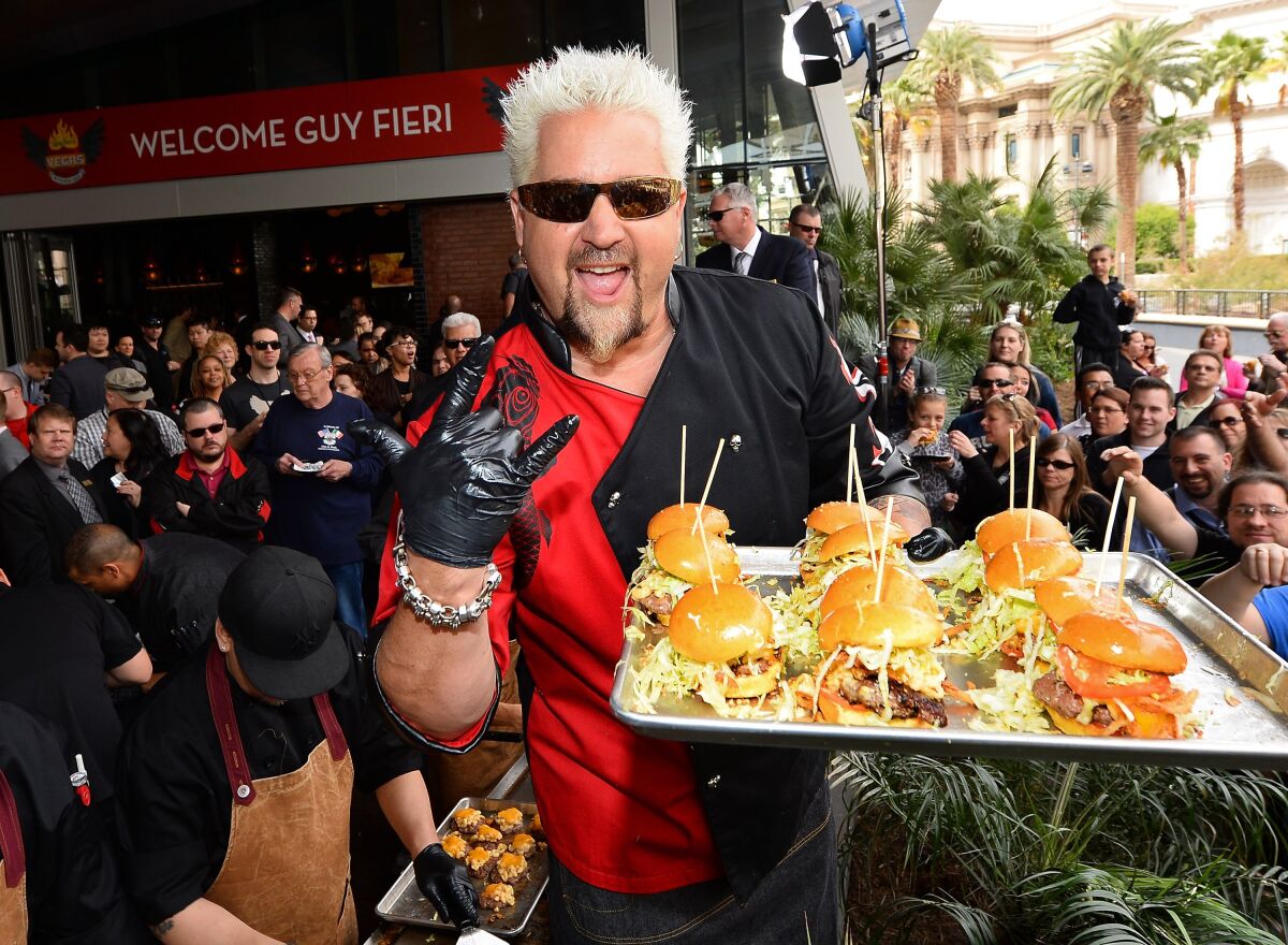 Guy Fieri poses at Guy Fieri's Vegas Kitchen & Bar at The Quad Resort & Casino on April 4, 2014 in Las Vegas, Nevada