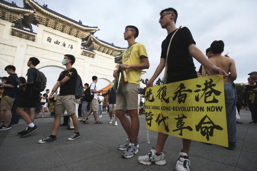 Hong Kong protesters in Taiwan and Taiwanese supporters gathered to mark the first anniversary of a mass rally in Hong Kong against its now-withdrawn extradition bill at Democracy Square in in Taipei, Taiwan, Saturday, June 13, 2020. (AP Photo/Chiang Ying-ying)