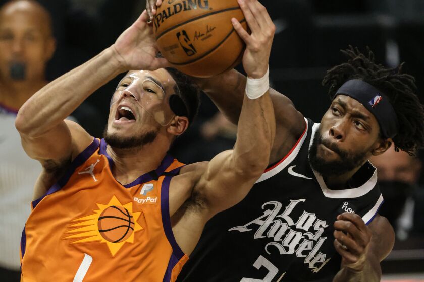 Thursday, June 24, 2021, Los Angeles CA - LA Clippers guard Patrick Beverley (21) fouls Phoenix Suns guard Devin Booker (1) late in the second quarter in Game three of the NBA Western Conference Finals at Staples Center. (Robert Gauthier/Los Angeles Times)