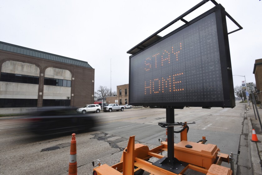 A sign encourages residents to stay home during the coronavirus outbreak Friday in St. Joseph, Mich.