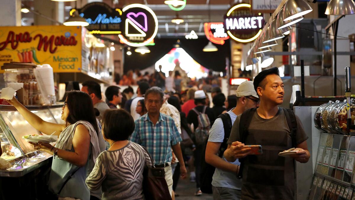 Diners make their way through the aisles at Grand Central Market.