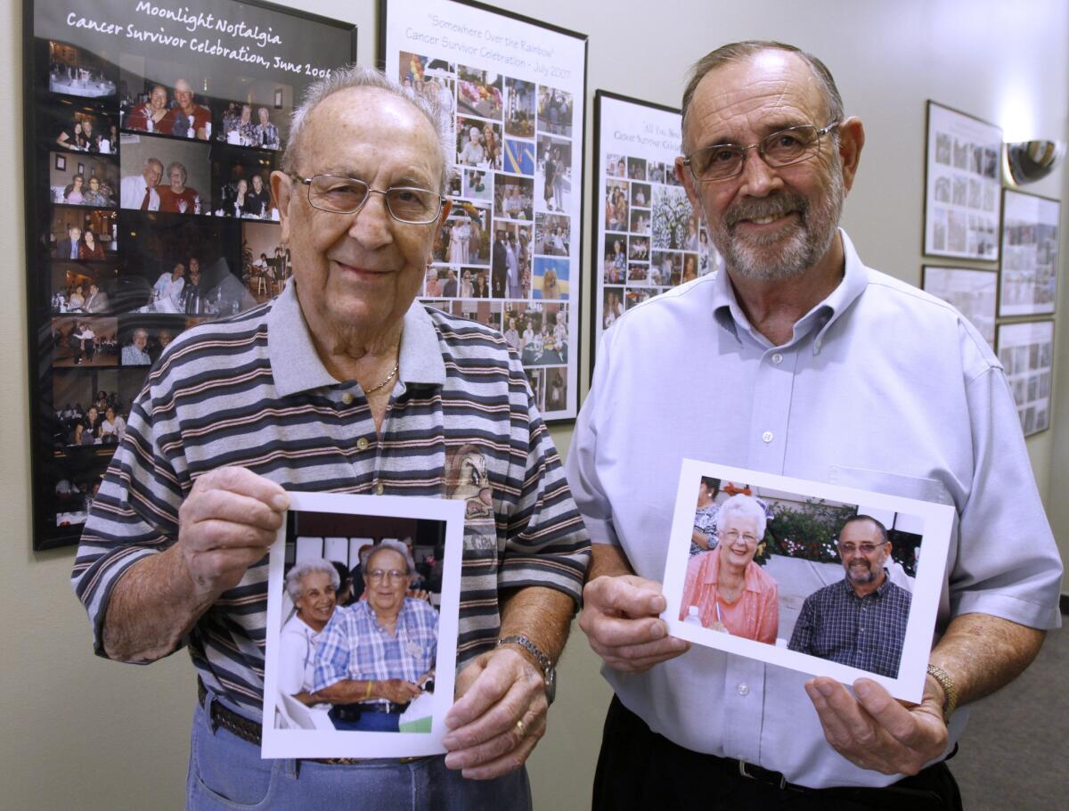 Gaspard Sossoyan, of Silver Lake, left, and Richard McDaniel, of La Crescenta, right, holding portraits of their wives and who are part of a breast cancer support group, are shown at the Glendale Memorial Hospital Breast Cancer Center in Glendale on Wednesday, Oct. 16, 2013. Their wives passed away in 2011 and 2012 respectively.