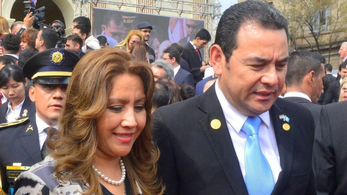 Guatemalan President Jimmy Morales and his wife, Patricia Marroquin, leave a cathedral after attending a Te Deum service after the inauguration ceremony of Paraguay's new president Wednesday.