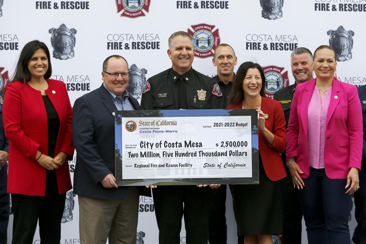 Costa Mesa city and fire officials received Friday $2.5 million to help fund a renovation of a firefighter training center.