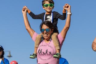 A woman and her son cross the finish line