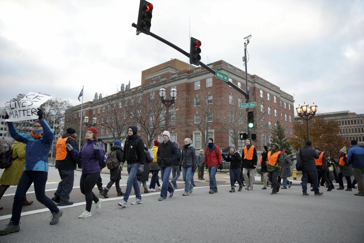 Protesters occupy an intersection outside the St. Louis County Police Department headquarters Tuesday, Nov. 25, 2014, in Clayton, Mo., in response to the Ferguson grand jury decision not to indict police officer Darren Wilson in the death of Michael Brown. (AP Photo/Jeff Roberson) The Associated Press