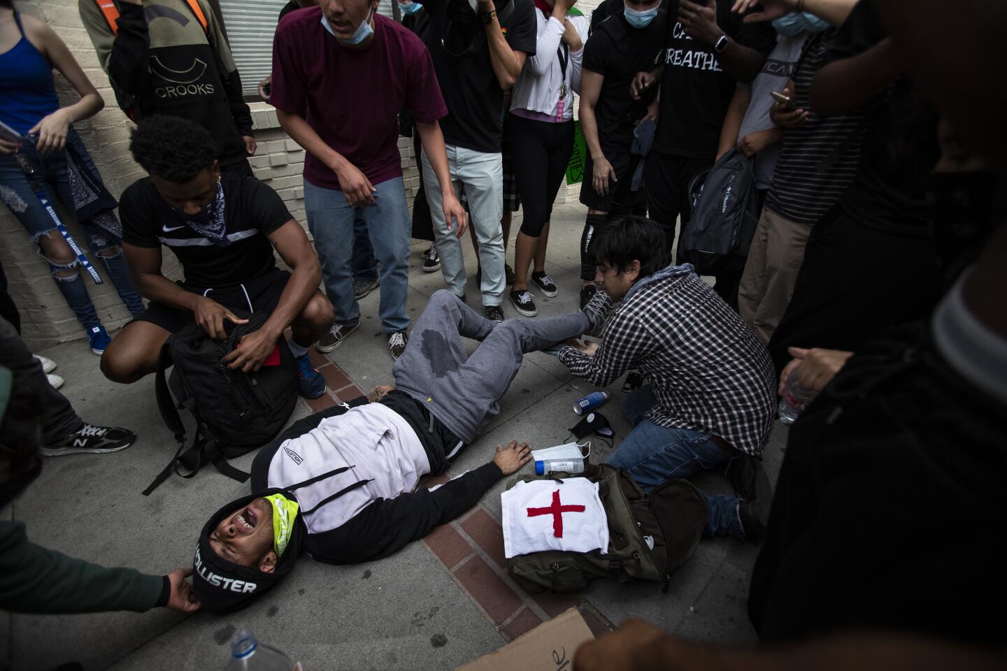 A protester screams in pain after being injured