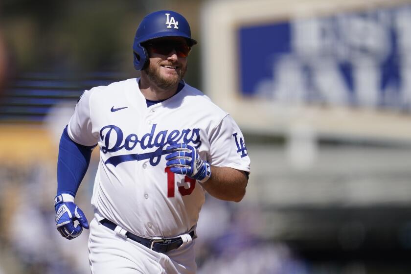 Los Angeles Dodgers' Max Muncy (13) runs the bases after hitting a home run during the eighth inning of a baseball game against the San Francisco Giants Sunday, May 30, 2021, in Los Angeles. Austin Barnes also scored. (AP Photo/Ashley Landis)