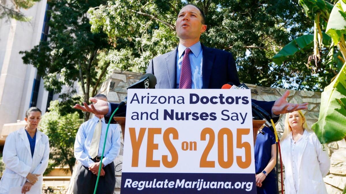 J.P. Holyoak, chair of the Campaign to Regulate Marijuana Like Alcohol, is joined by a host of doctors and nurses at the Arizona capitol to endorse Proposition 205, which would legalize recreational marijuana.