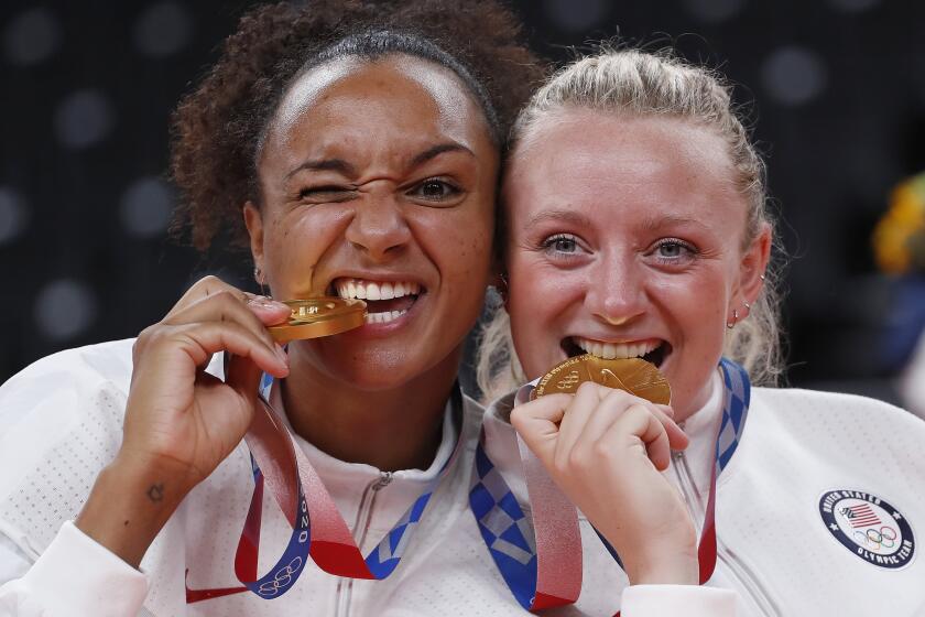 TOKYO, - AUGUST 08: Gr.Am1019$ Jordan Thompson on left and Jordyn Poulter clown around with their gold medals. U.S. vs Brazil gold medal women's volleyball game. This is during the Tokyo Olympics.Tokyo Olympics on Sunday, Aug. 8, 2021 in Tokyo, {stmens}. (Gary Ambrose / For the Times)