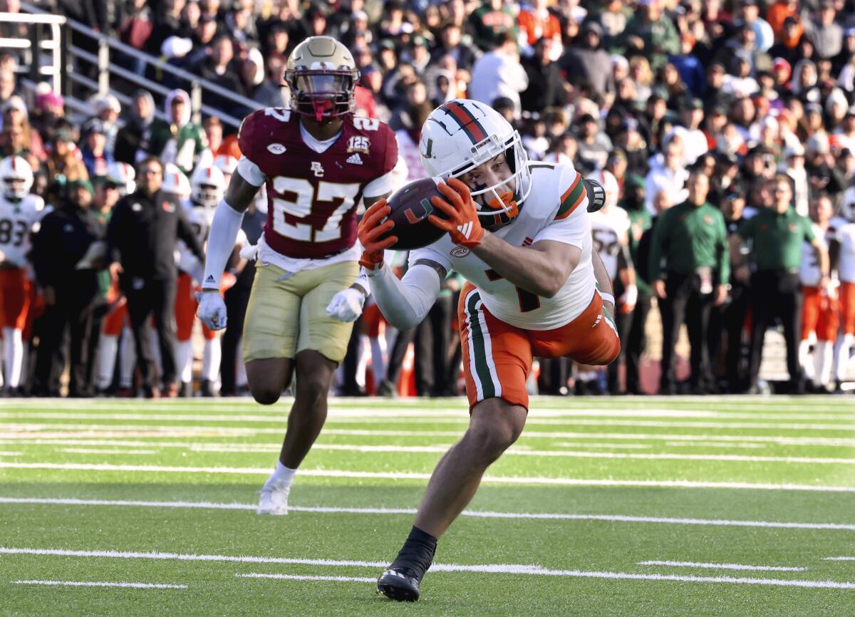 Miami wide receiver Xavier Restrepo (7) reaches out for a completed pass during the second half of an NCAA college football game against Boston College, Friday, Nov. 24, 2023, in Boston. (AP Photo/Mark Stockwell)