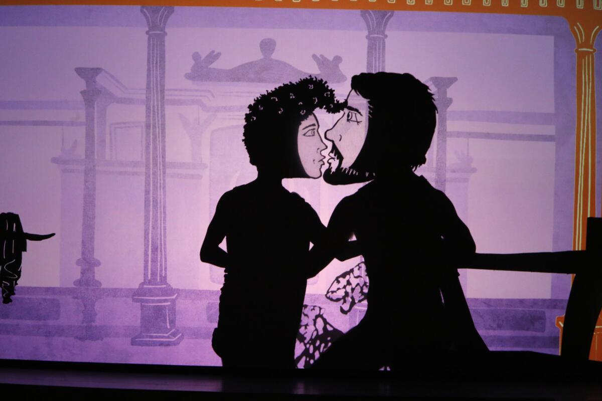 Shadow puppets of Caesar, left, and King Nicomedes share an intimate moment in the Lou Harrison opera "Young Caesar," with its message about enjoying life rather than making war.