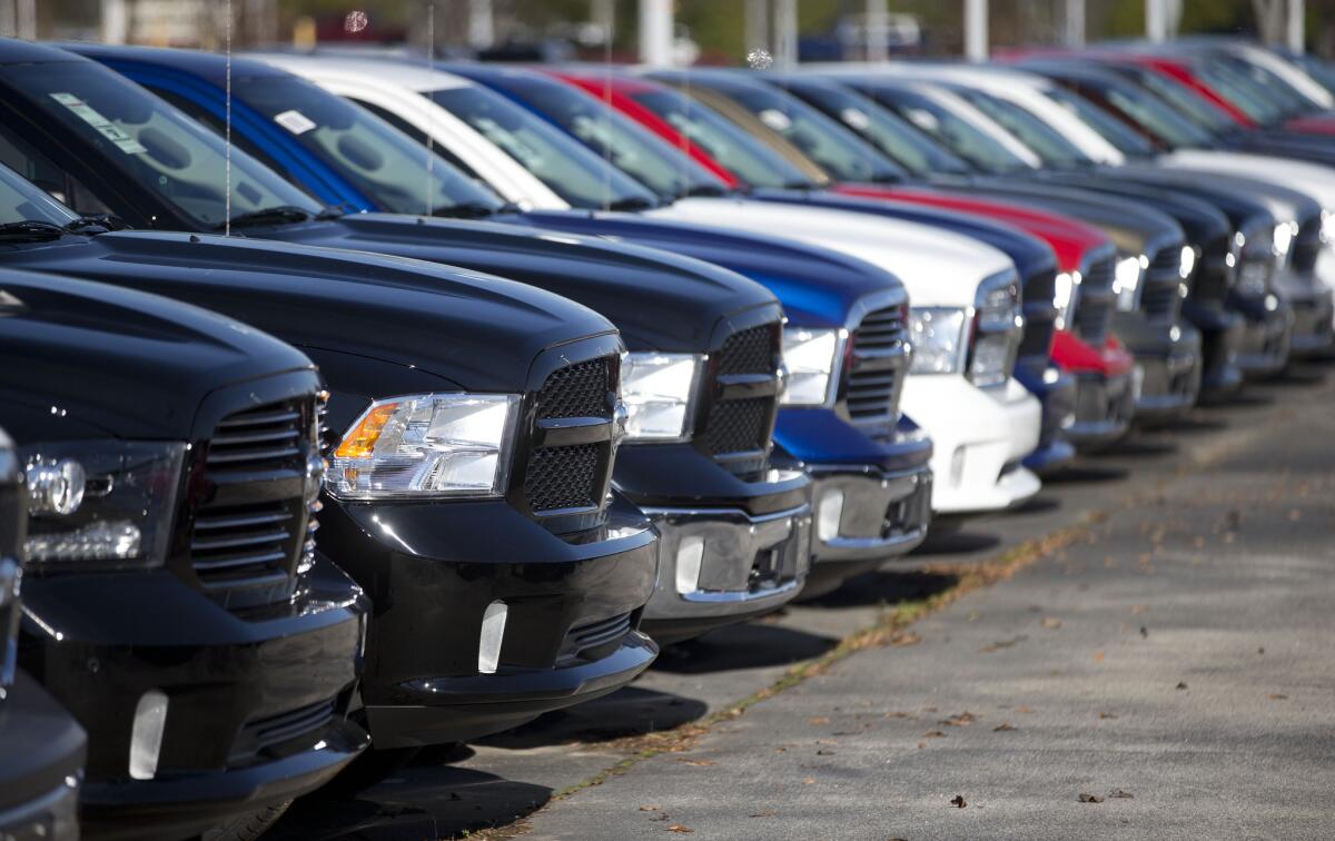 The Environmental Protection Agency reports that fuel economy numbers did not advance for the 2014 model year, probably because American vehicle buyers leaned more heavily toward gas-guzzling trucks than fuel-sipping sedans. Shown, Dodge pickup trucks on display at a dealership in Morrow, Ga., on Jan. 5, 2015.