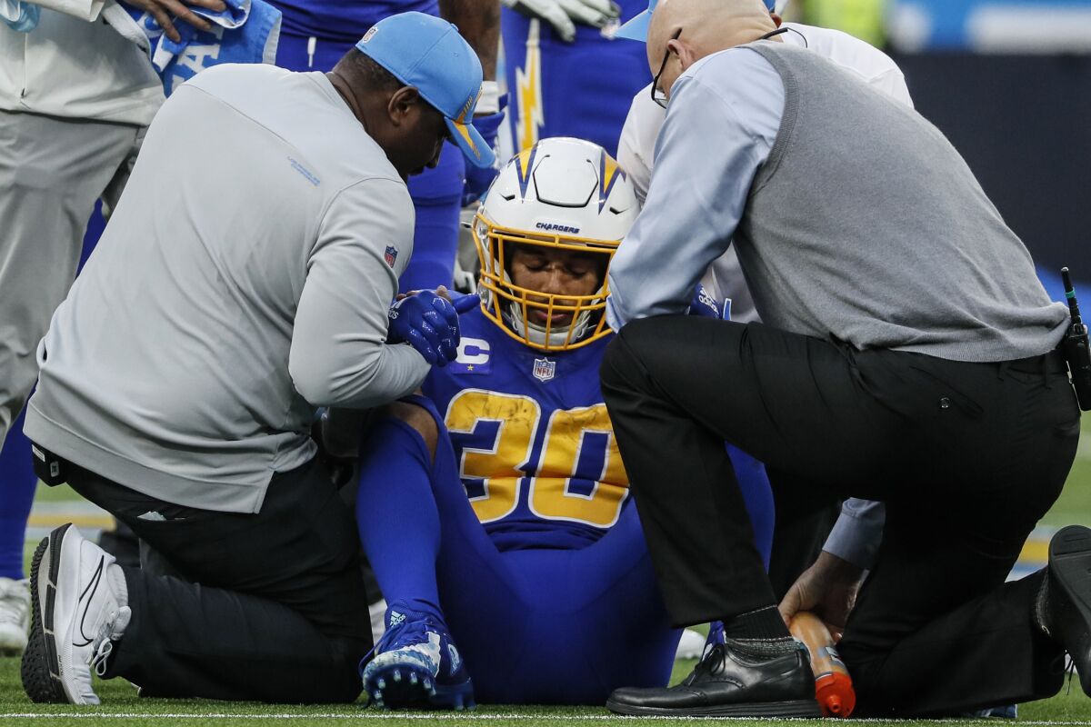  Chargers running back Austin Ekeler, who injured his ankle against the Giants, is helped off the field.