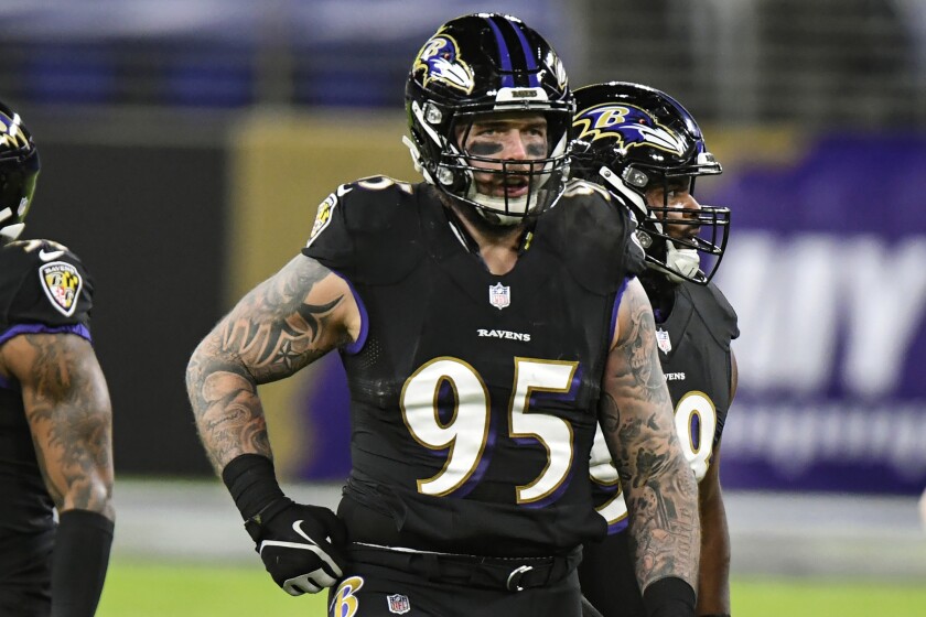 Baltimore Ravens defensive end Derek Wolfe (95) looks on during the first half of an NFL football game against the Dallas Cowboys, Tuesday, Dec. 8, 2020, in Baltimore. Wolfe, an energetic and talented defensive end, lost his passion for the game during a miserable four-year stretch in Denver that featured three head coaches, 37 defeats and not a single trip to the postseason. So he took a one-year deal with Baltimore, and now Wolfe and the Ravens are right where they want to be in the middle of January: still alive in the playoffs and very much in the running for a trip to the Super Bowl. (AP Photo/Terrance Williams, File)