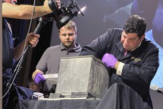 Paul Hudson, left, West Point archeologist, and Michael Diaz, West Point Museum curator, take part in the opening of a lead box believed to have been placed in the base of a monument by cadets almost two centuries ago, at the U.S. Military Academy, Monday, Aug. 28, 2023, in West Point, N.Y. The box contained silt. (AP Photo/Michael Hill)