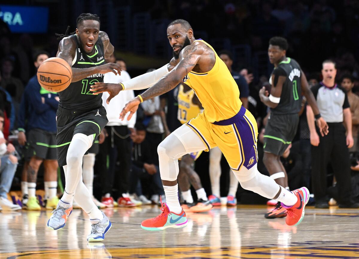 Lakers forward LeBron James has the ball knocked away by Timberwolves forward Taurean Prince.