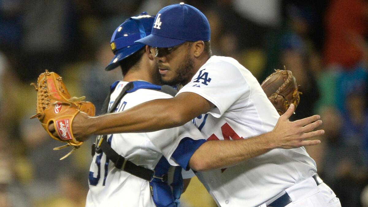Dodgers closer Kenley Jansen, right, celebrates with catcher Drew Butera following the team's 5-2 win over the Chicago White Sox at Dodger Stadium on Monday.
