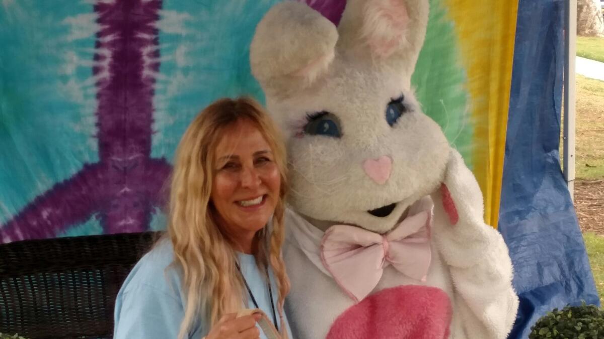 Costa Mesa Realtor Valerie Torelli poses with the Easter Bunny during a 2019 Egg-Citement event at Tanager Park.