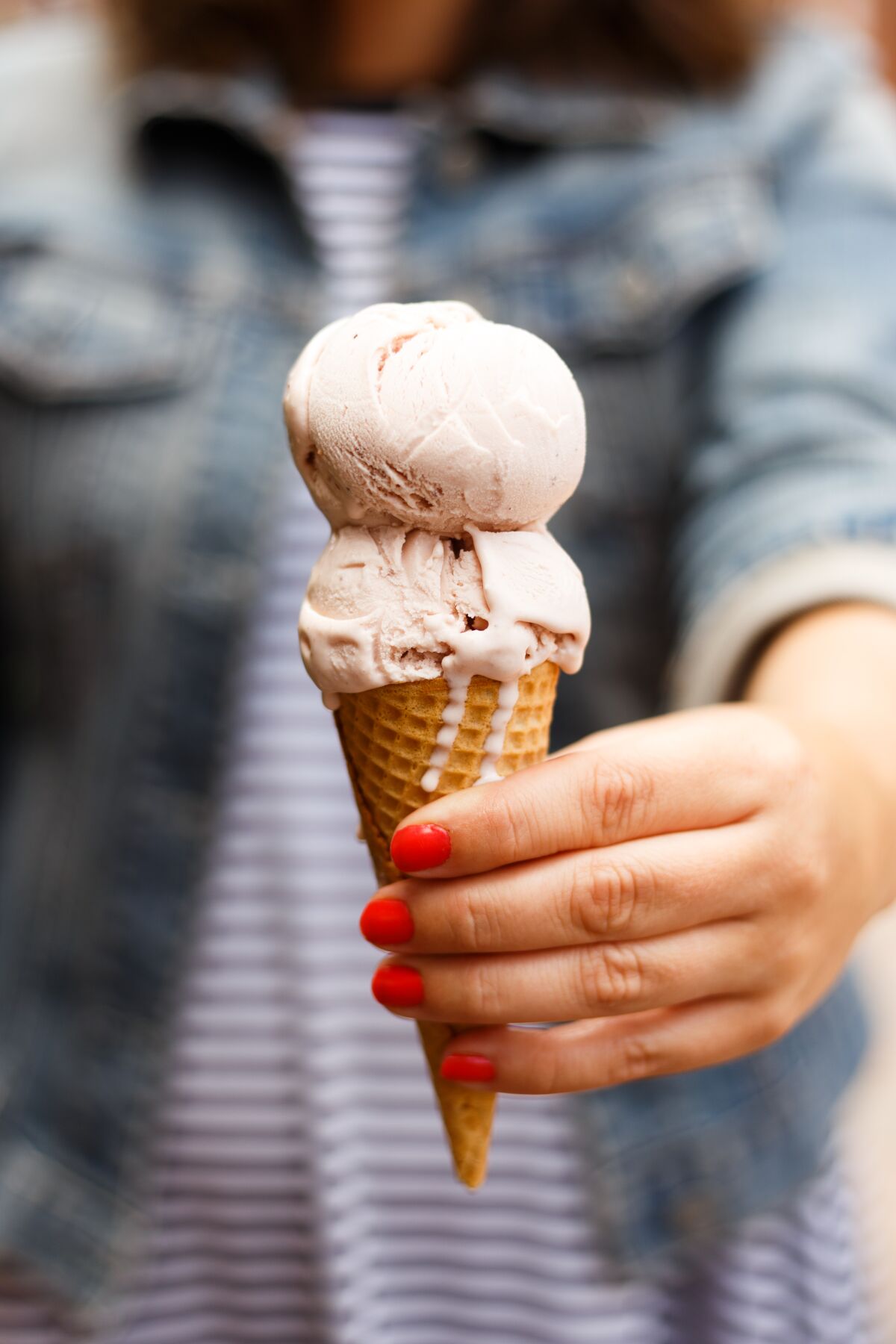 A cone of roasted strawberry ice cream from Jeni's Splendid Ice Creams 